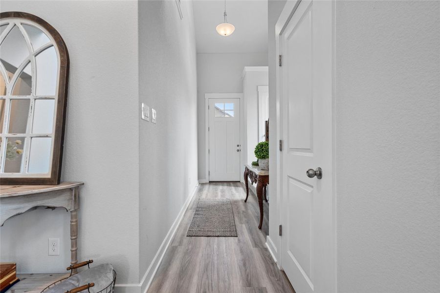 Hallway featuring wood finished floors and baseboards Hallway featuring wood finished floors and baseboards