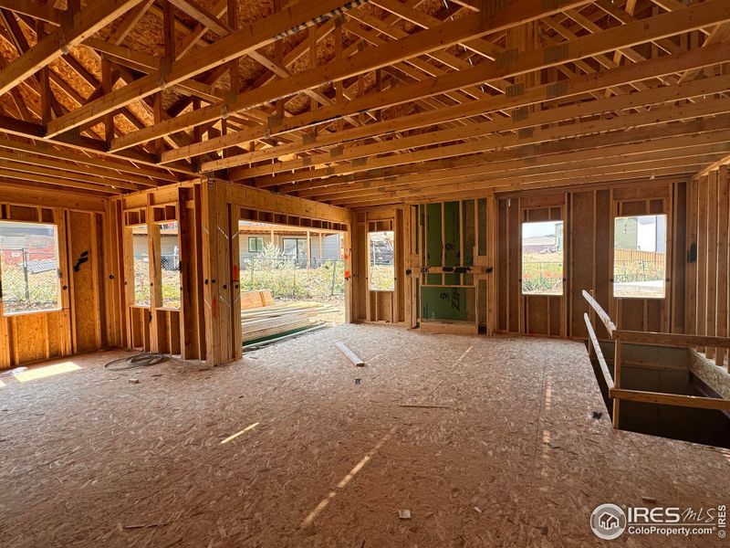 Family Room w/ Fireplace and Western Doors Opening to Covered Patio