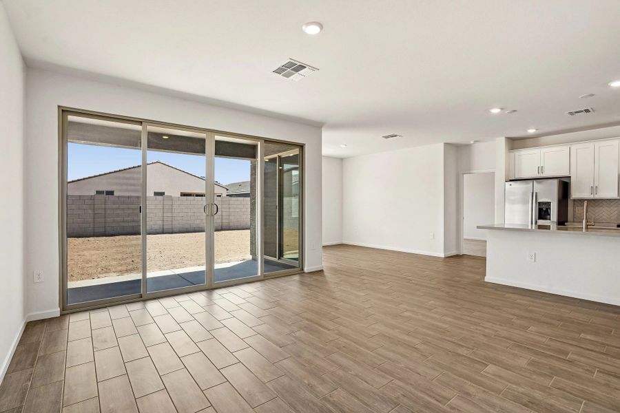 Great room with 4 panel slider to covered patio. Not actual home, options and finishes may vary.