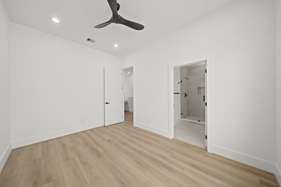 A view of the second bedroom with the third floor corridor in the background as well as access to the ensuite bath.