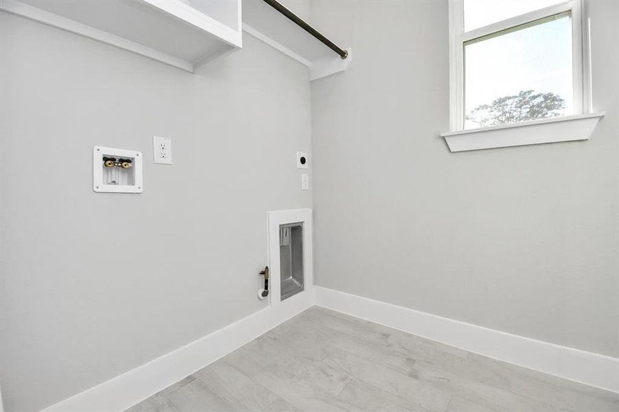 A perfect blend of functionality and comfort. Capture the essence of easy living with a first-floor laundry room, thoughtfully equipped with shelving for effortless organization. Bothelectric and gas connections available.