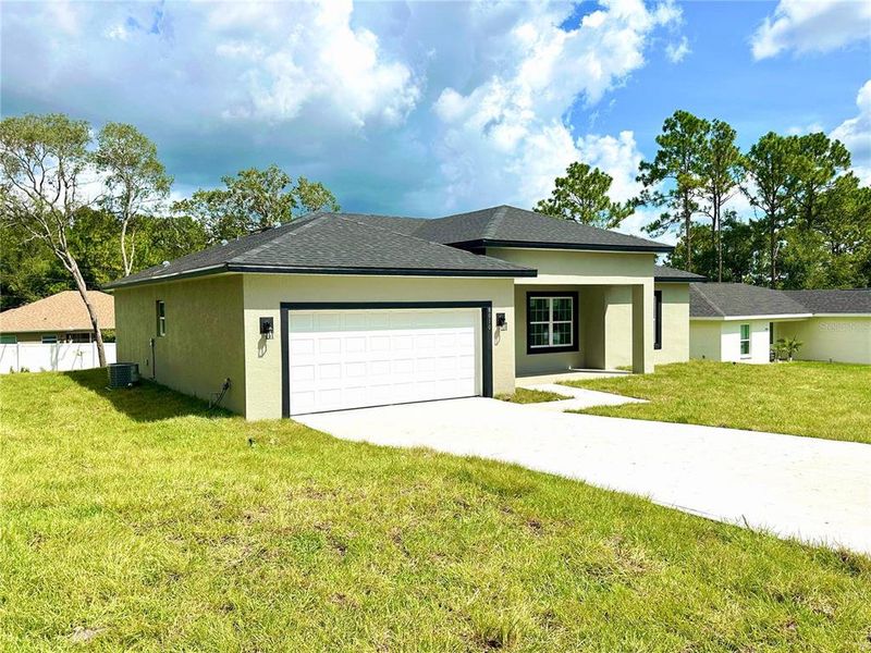 Front exterior of a new home in , Citrus Springs, FL, highlighting curb appeal (Image 2).