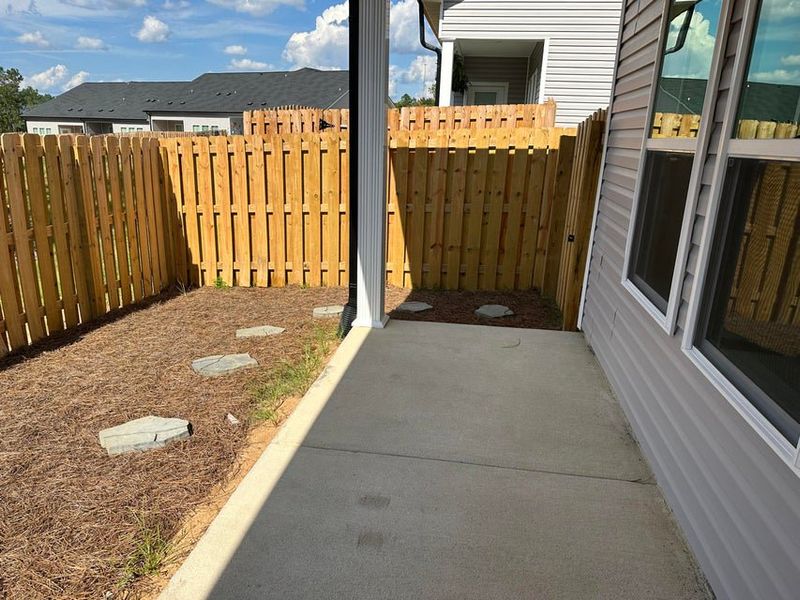Exterior details and patio area of a home in Windsor Townhomes, North Augusta (Image 15).