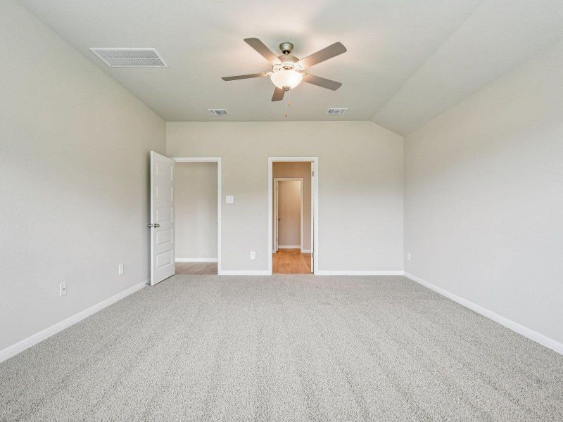 Unfurnished bedroom featuring carpet, lofted ceiling, and a ceiling fan Unfurnished bedroom featuring carpet, lofted ceiling, and a ceiling fan