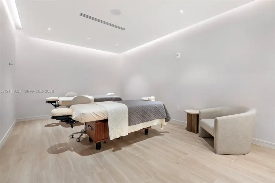 Neutral interior space featuring wood-finish flooring, recessed ceiling lighting, and perimeter cove lighting Neutral interior space featuring wood-finish flooring, recessed ceiling lighting, and perimeter cove lighting