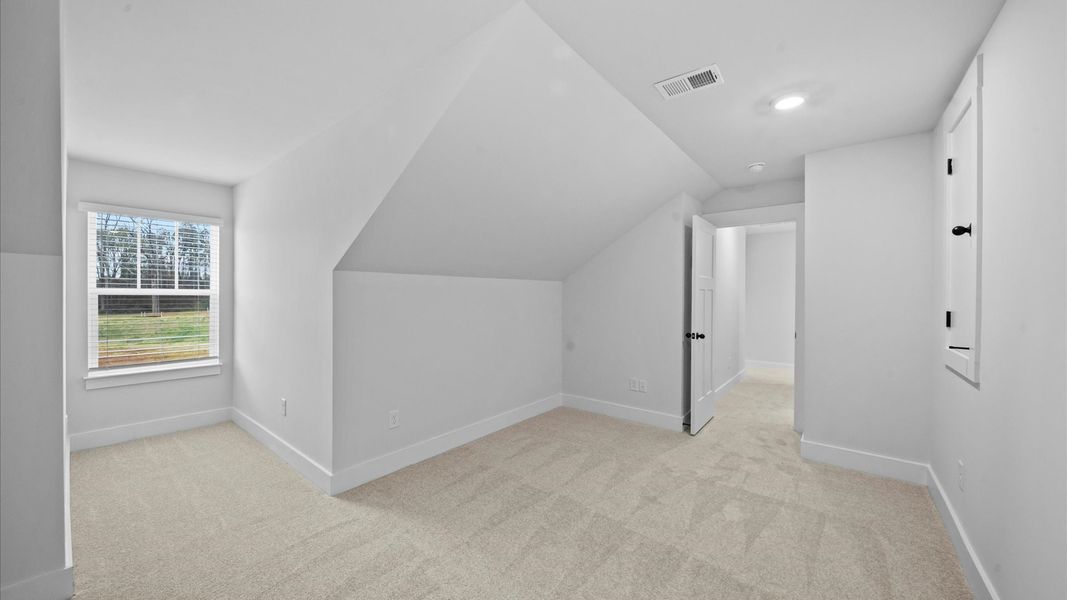 Inviting loft with cozy carpet, perfect for casual gatherings or quiet relaxation Inviting loft with cozy carpet, perfect for casual gatherings or quiet relaxation