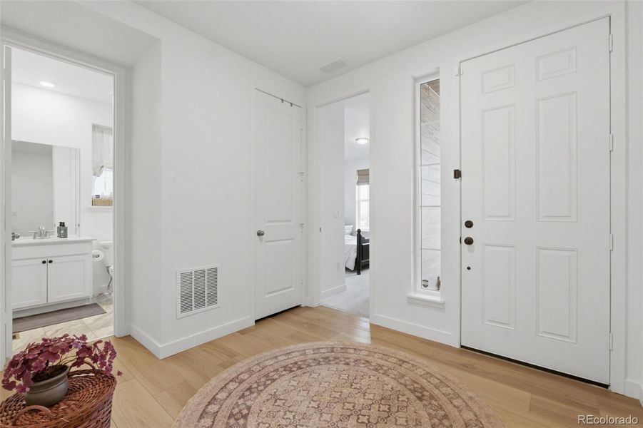 Front door and entrance to bedroom 2 and second full bathroom