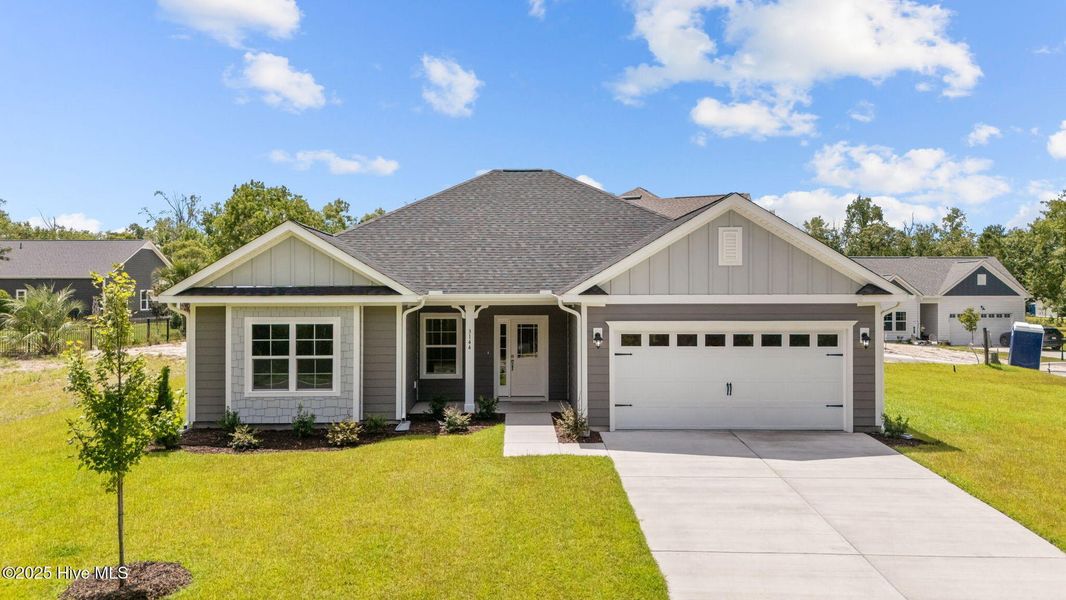 Front exterior of a new home in Rutledge, Shallotte, NC, highlighting curb appeal (Image 1).