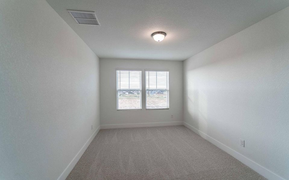 Carpeted empty room featuring baseboards Carpeted empty room featuring baseboards