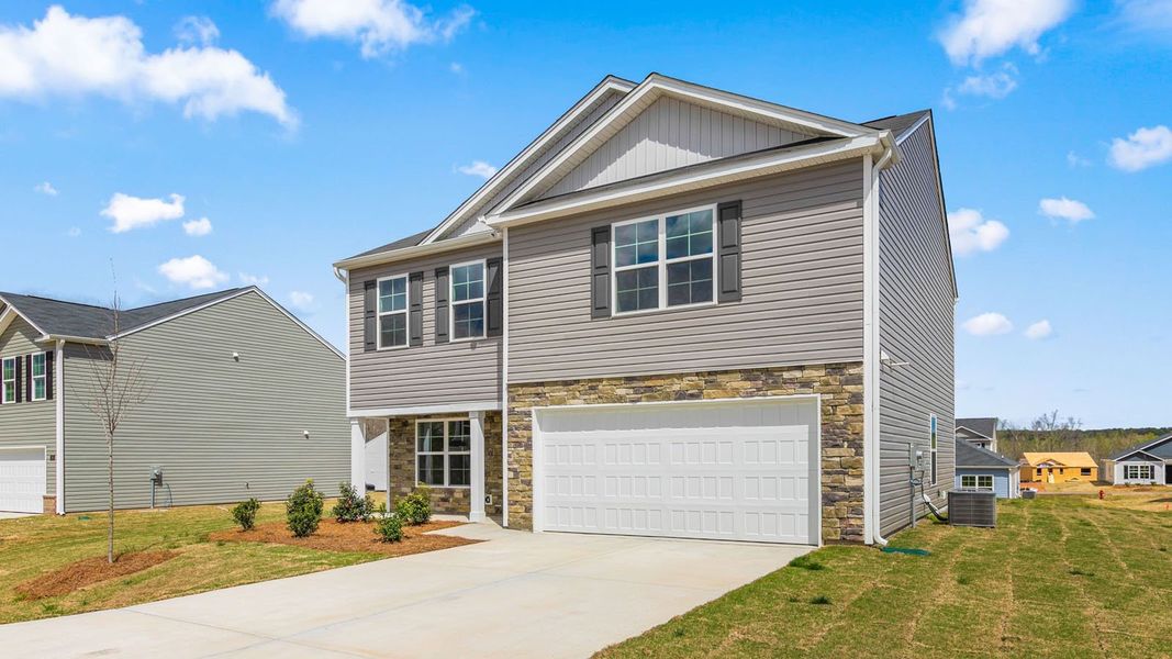 Front exterior of a new home in The Reserve at Stoney Creek, Whitsett, NC, highlighting curb appeal (Image 2). Front exterior of a new home in The Reserve at Stoney Creek, Whitsett, NC, highlighting curb appeal (Image 2).