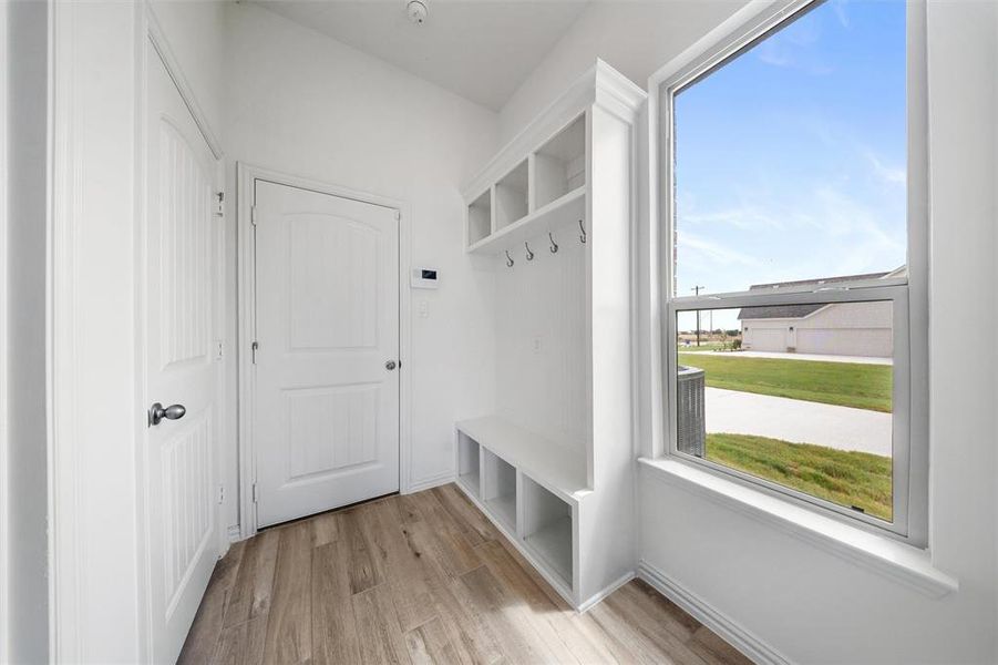 Mudroom featuring light wood-type flooring and baseboards Mudroom featuring light wood-type flooring and baseboards