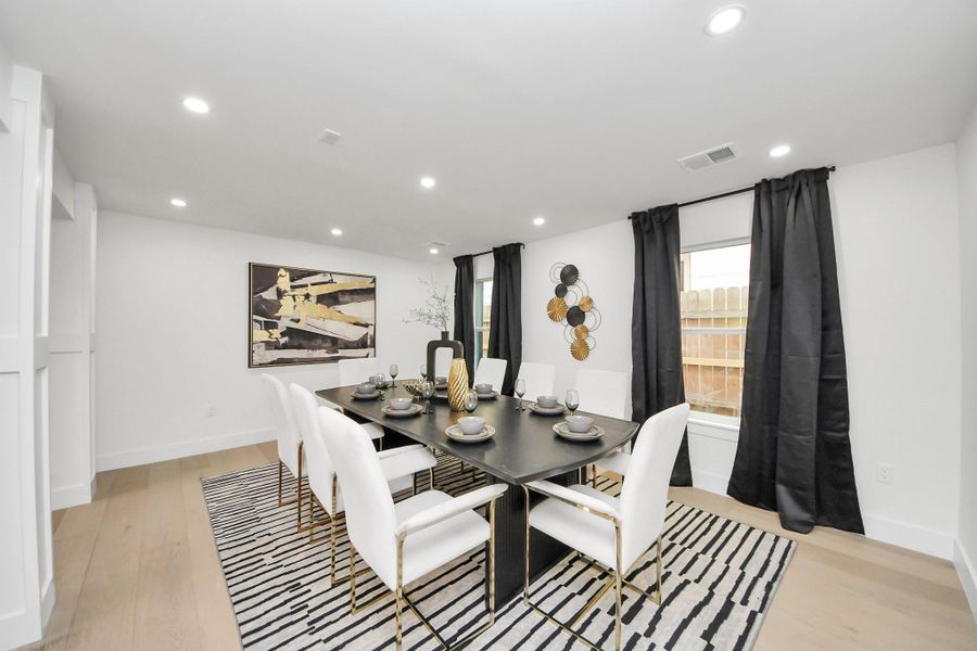 The formal dining room easily fits a table set for eight. Recessed lighting and large windows create a bright and inviting atmosphere. The formal dining room easily fits a table set for eight. Recessed lighting and large windows create a bright and inviting atmosphere.