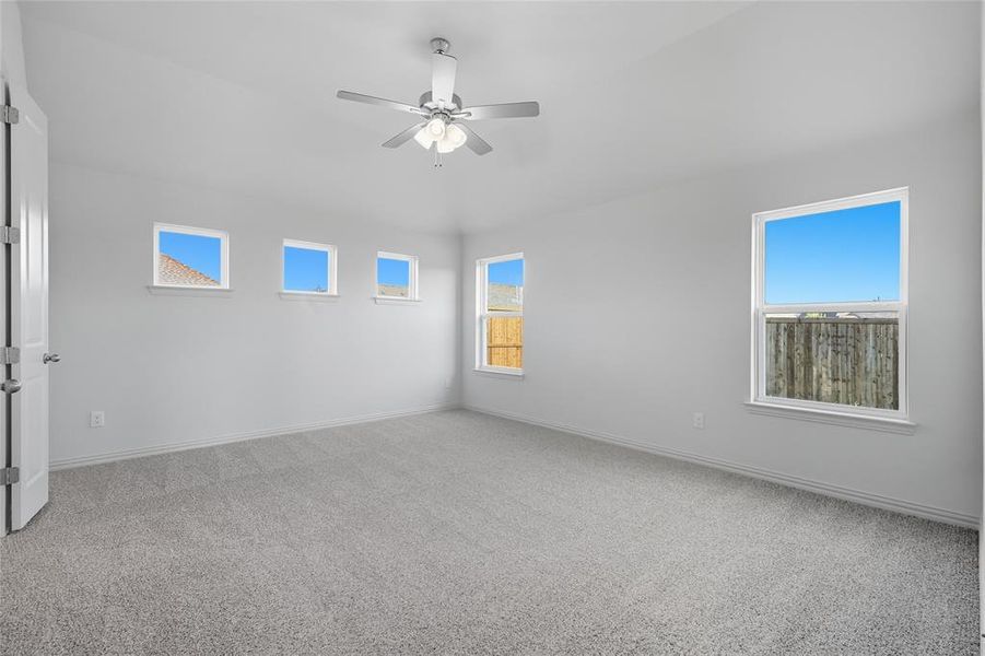 Spare room with light carpet and a ceiling fan Spare room with light carpet and a ceiling fan