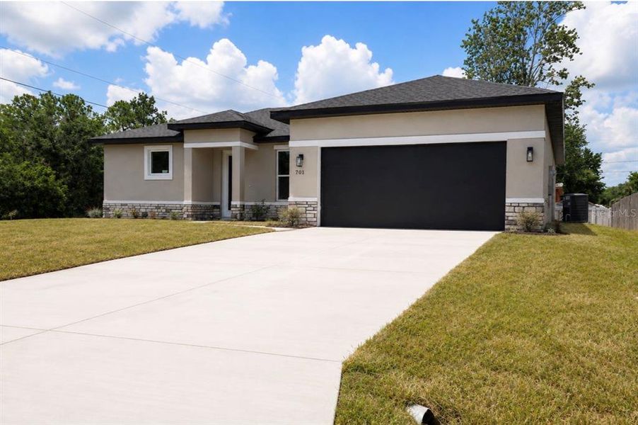 Front exterior of a new home in , Poinciana, FL, highlighting curb appeal (Image 20). Front exterior of a new home in , Poinciana, FL, highlighting curb appeal (Image 20).