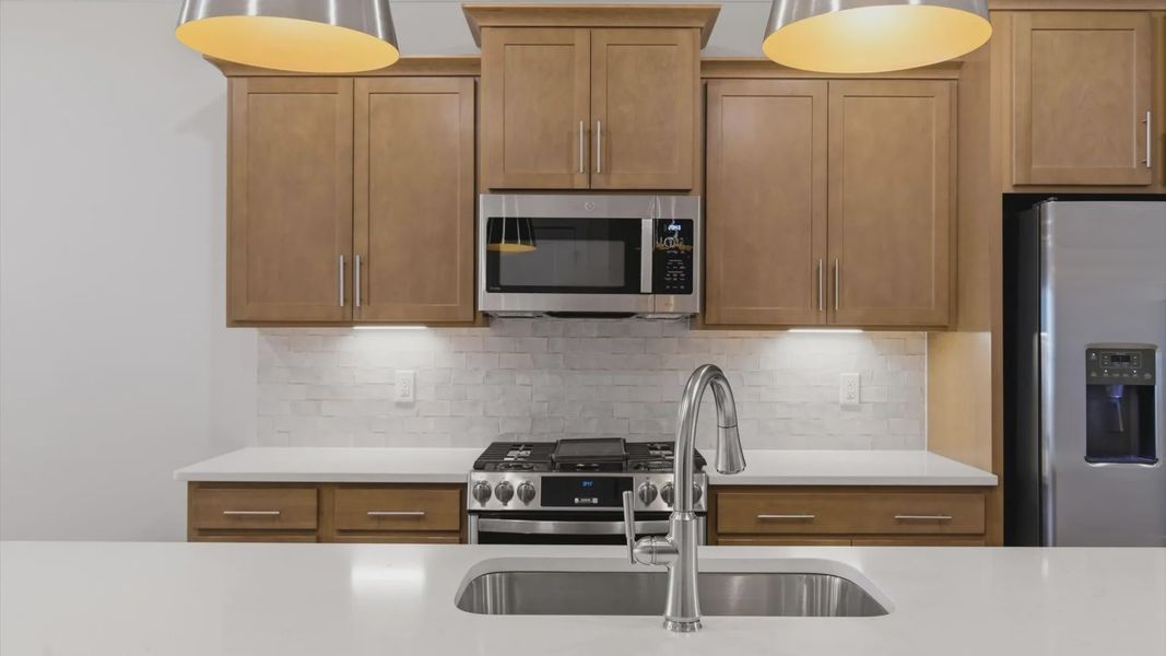 Exceptional kitchen featuring a spacious island, eye-catching pendant lights, and modern finishes located in Greenville, SC