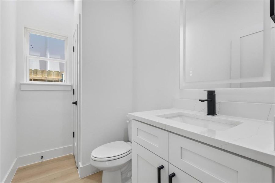 Half bath with vanity and light wood-style floors Half bath with vanity and light wood-style floors