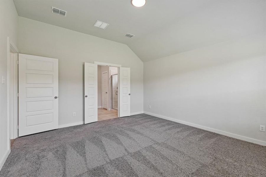 Primary bedroom in the Quartz home plan by Trophy Signature Homes – REPRESENTATIVE PHOTO