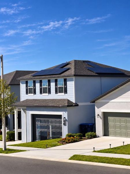 Front exterior of a new home in , Haines City, FL, highlighting curb appeal (Image 1). Front exterior of a new home in , Haines City, FL, highlighting curb appeal (Image 1).