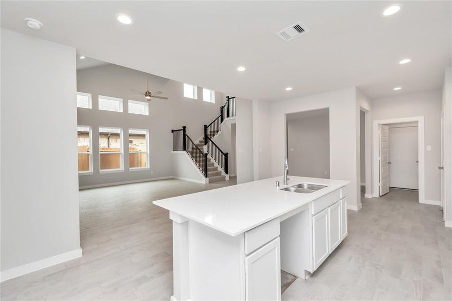 All of this overlooks your expansive family room, creating a perfect space for culinary delights and family gatherings. Sample photo of completed home with similar floor plan. As-built interior colors and selections may vary