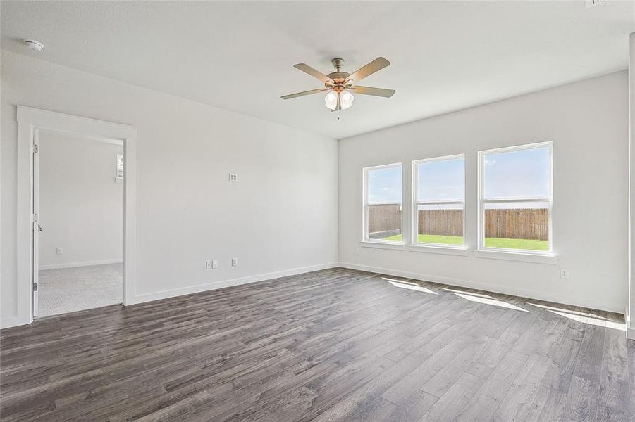 Unfurnished room with ceiling fan and dark wood-type flooring