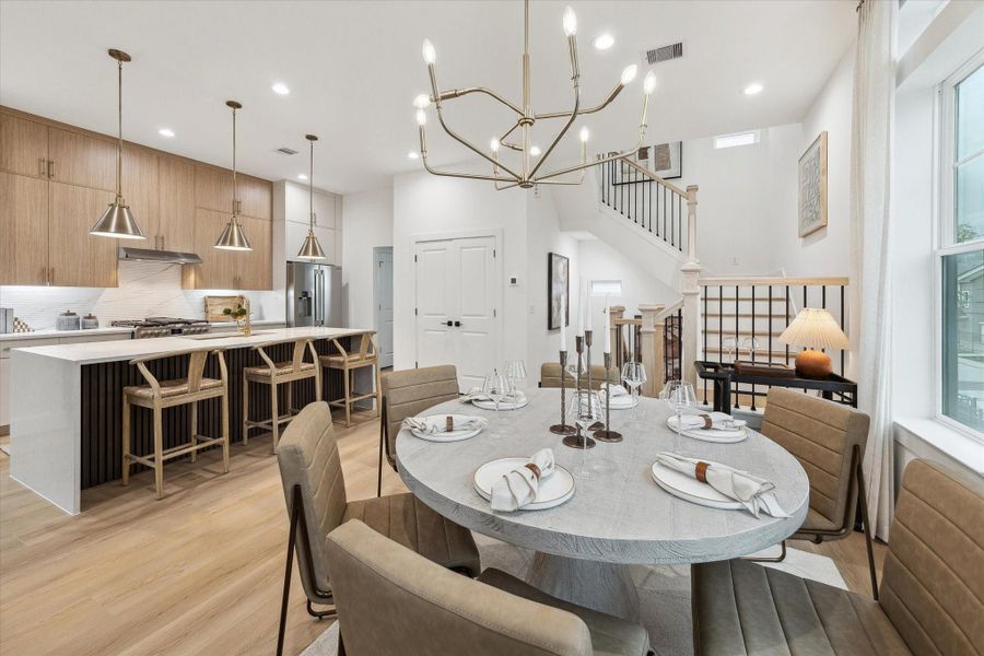 Light-filled open-concept dining and kitchen with modern finishes Light-filled open-concept dining and kitchen with modern finishes