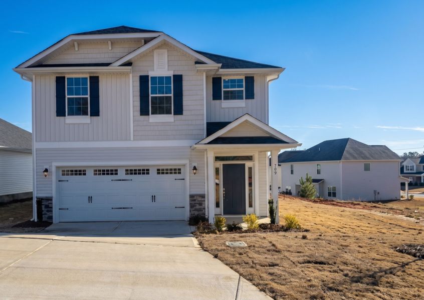 Front exterior of a new home in Village at Parkside, Gastonia, NC, highlighting curb appeal (Image 1). Front exterior of a new home in Village at Parkside, Gastonia, NC, highlighting curb appeal (Image 1).