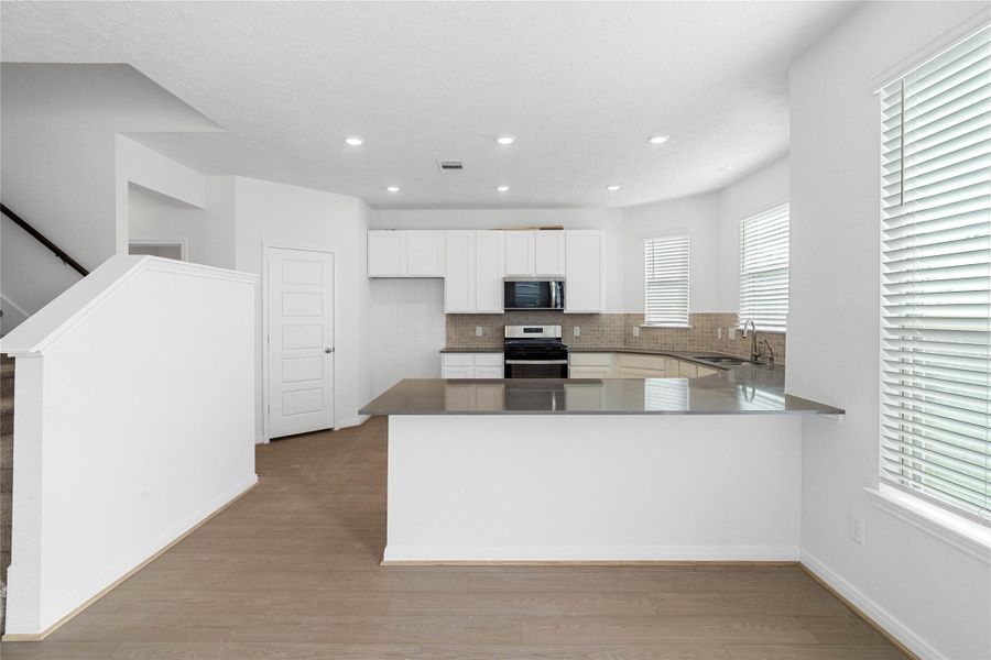 This spacious kitchen has it all—ample storage, generous counter space, and a layout that truly makes it the heart of the home.