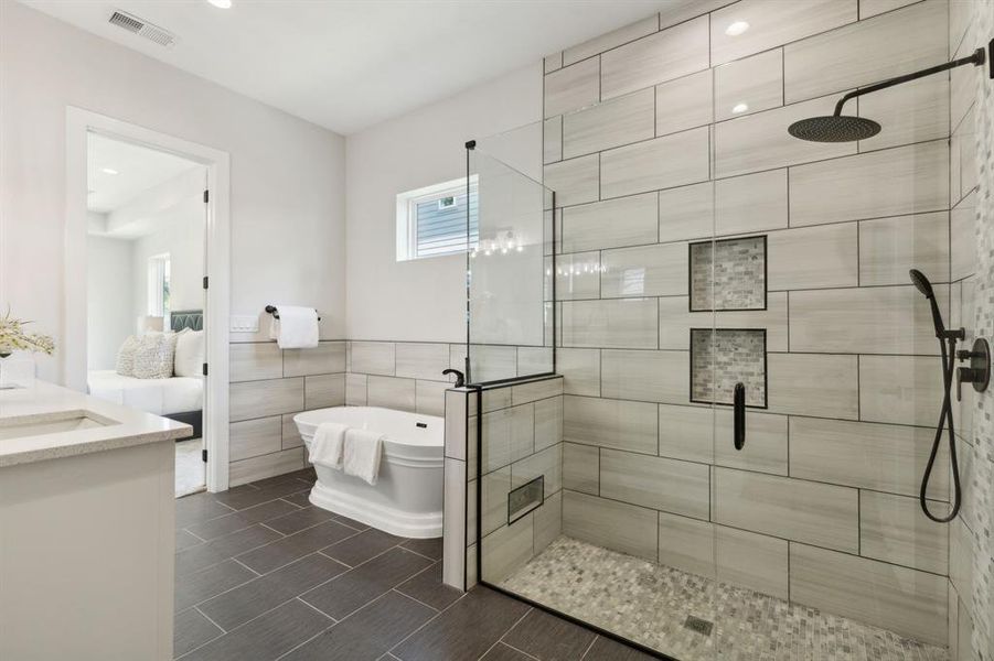 Stunning primary bathroom with freestanding soaking tub.