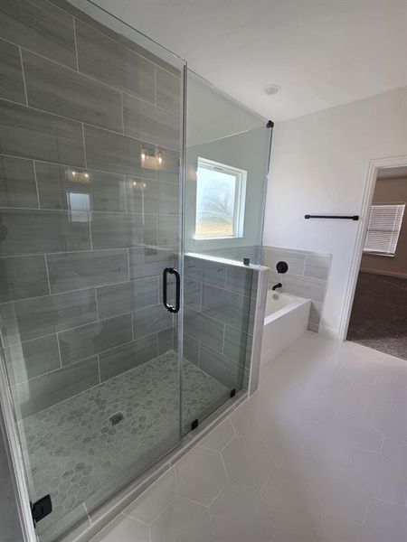 Full bath with a garden tub, a stall shower, and tile patterned flooring