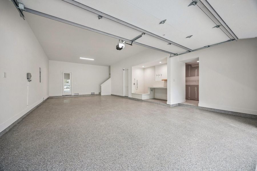 Incredible Four Car Garage with an Epoxy Treated Floor, plus extra storage and access to the elevator shaft.  The Garage is also Pre-Wired for Two 220V Outlets.