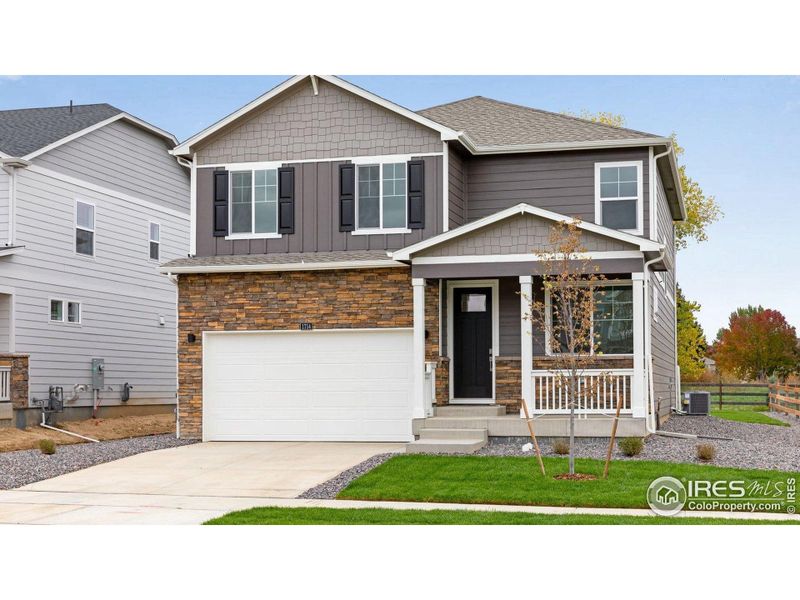 Front exterior of a new home in Brighton Crossing, Brighton, CO, highlighting curb appeal (Image 1).