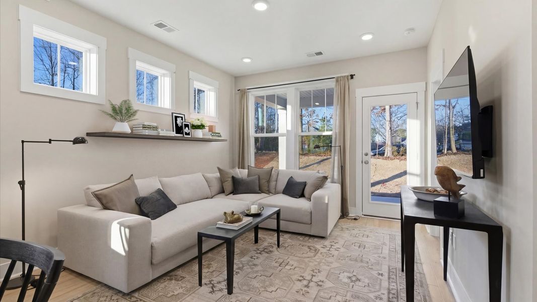 Memorable moments begin in this elegant, open family room with hardwood flooring and refined finishes in Greenville, SC