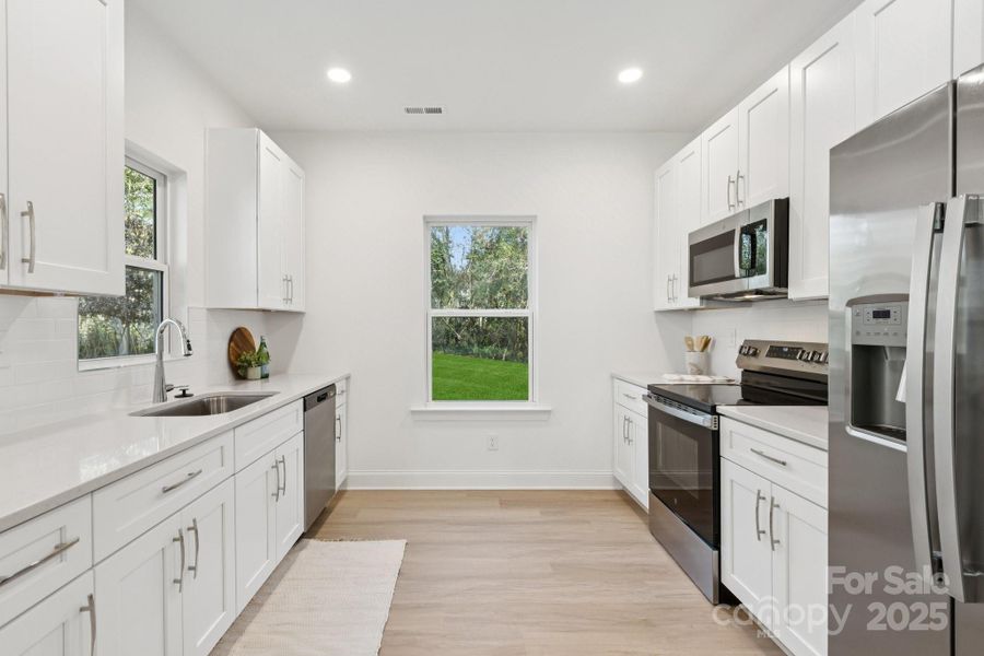 Bright kitchen with stainless-steel appliances & soft-close drawers