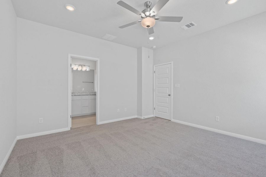 Unfurnished bedroom featuring light colored carpet, recessed lighting, connected bathroom, and ceiling fan