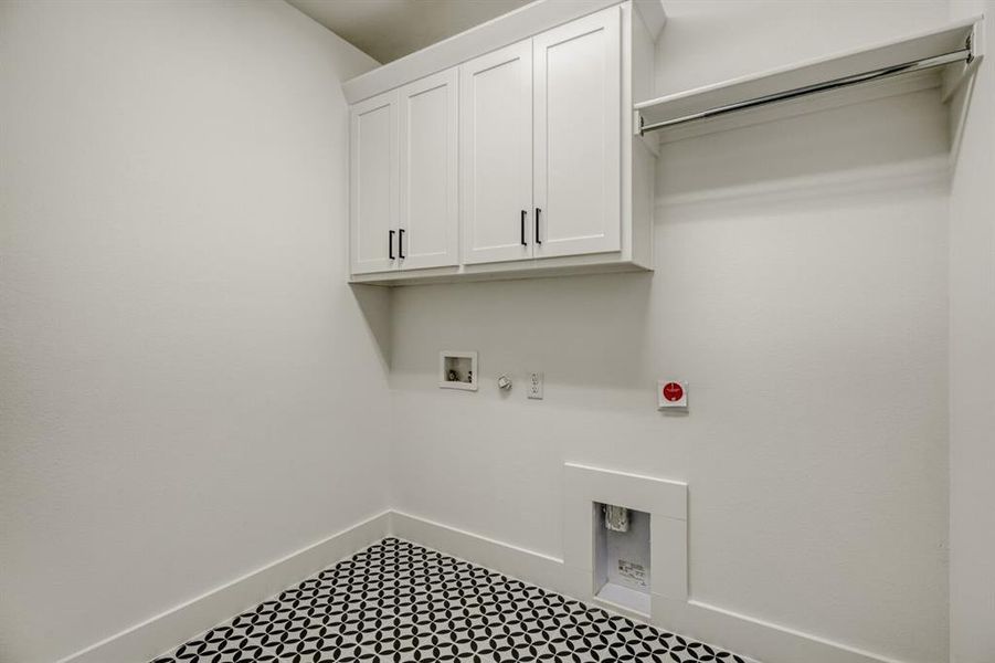Laundry room featuring hookup for a gas dryer, cabinet space, hookup for a washing machine, and tile patterned floors