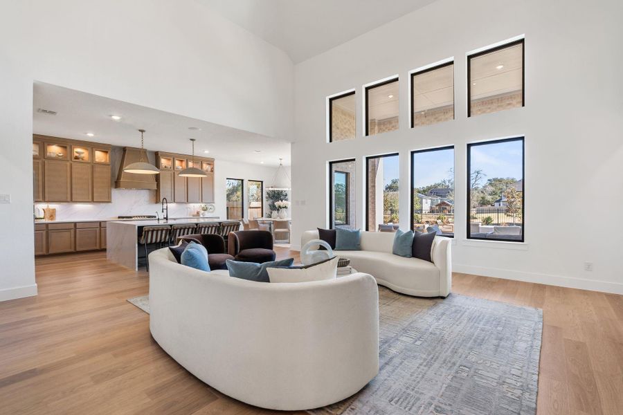 Light-filled open concept living space featuring soaring ceilings and expansive windows Light-filled open concept living space featuring soaring ceilings and expansive windows
