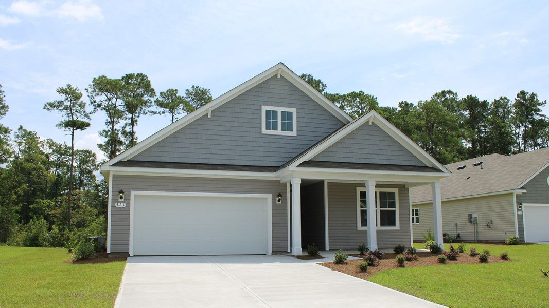 Front exterior of a new home in The Preserve at Shaftesbury Glen, Conway, SC, highlighting curb appeal (Image 2).