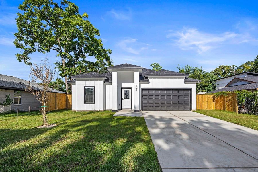 Charming modern home with a sleek facade, attached two-car garage, and a spacious front yard, nestled in a serene neighborhood.