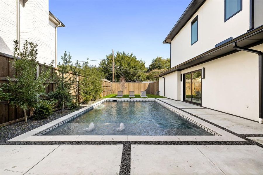View of swimming pool with a fenced backyard and a patio area View of swimming pool with a fenced backyard and a patio area