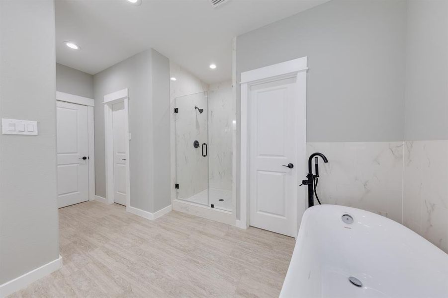 Primary bath featuring a private toilet area with direct access to the spacious walk-in closet for ultimate convenience.