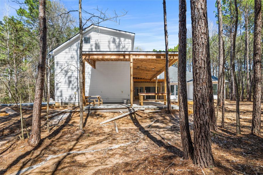 Private, wooded setting showcasing scale and seclusion and wrap around extended covered loggia.