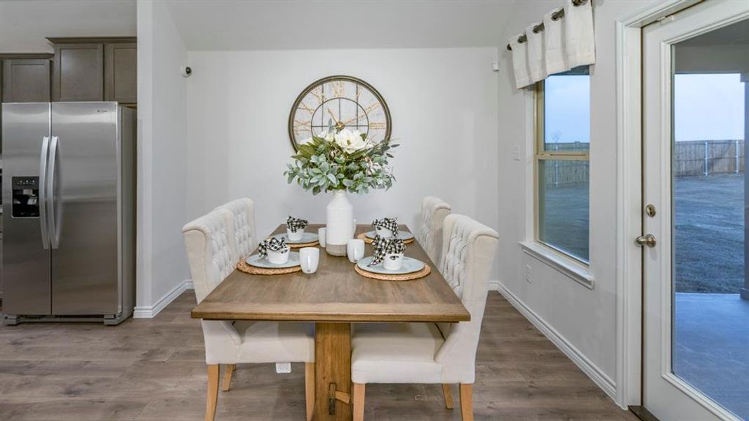 Dining area with light wood-style flooring Dining area with light wood-style flooring