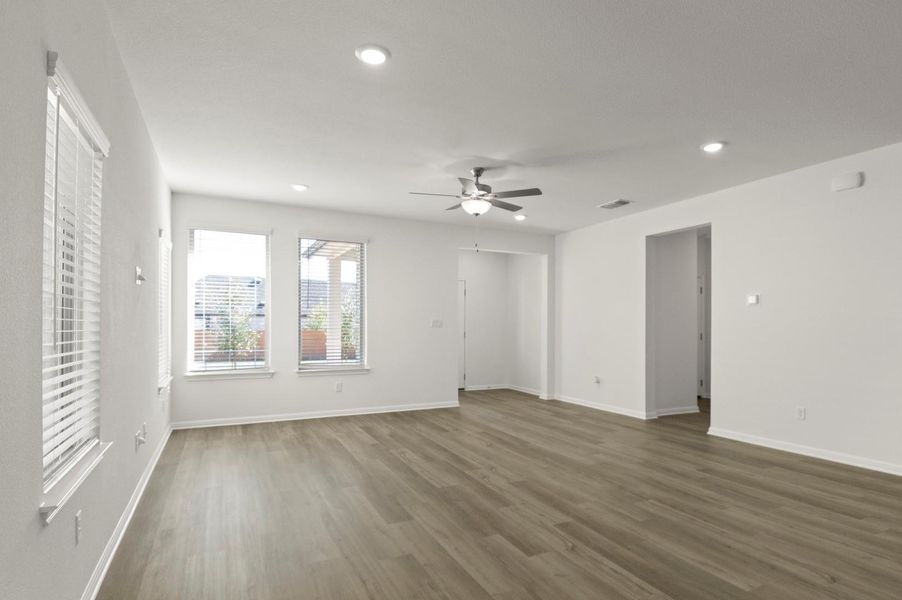 Unfurnished living room with dark wood finished floors, recessed lighting, and a ceiling fan