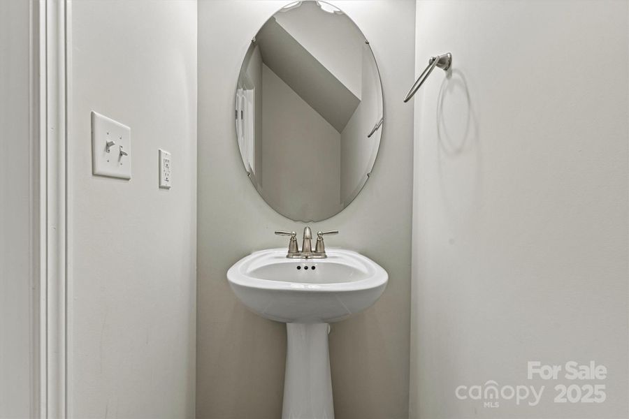 Conveniently located on the main floor, the half bath offers a stylish and accessible space for guests during gatherings or everyday visits Conveniently located on the main floor, the half bath offers a stylish and accessible space for guests during gatherings or everyday visits