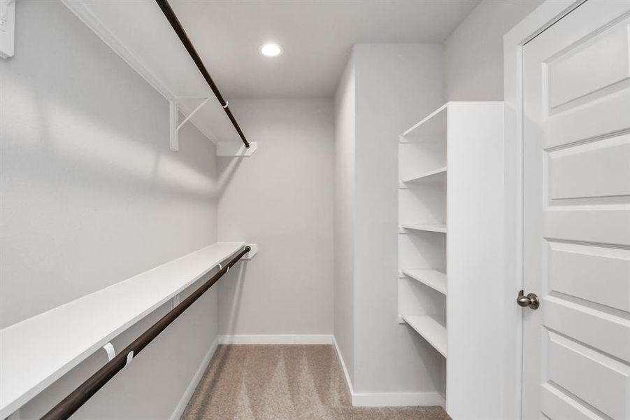 Spacious primary walk in closet with built ins. Sample photo of completed home with similar plan. Sample photo of similar plan. As-built color and selections may vary.