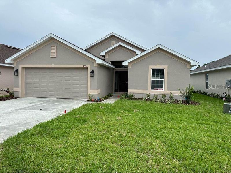 Front exterior of a new home in , Ocala, FL, highlighting curb appeal (Image 1).