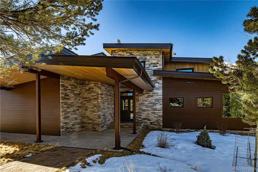 Earth tone brick walk-way with staked stone and cedar T&G covered porch entrance Earth tone brick walk-way with staked stone and cedar T&G covered porch entrance