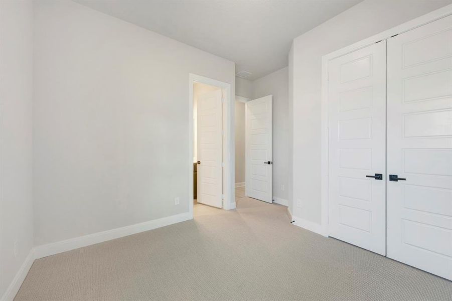 Unfurnished bedroom with carpet and a closet