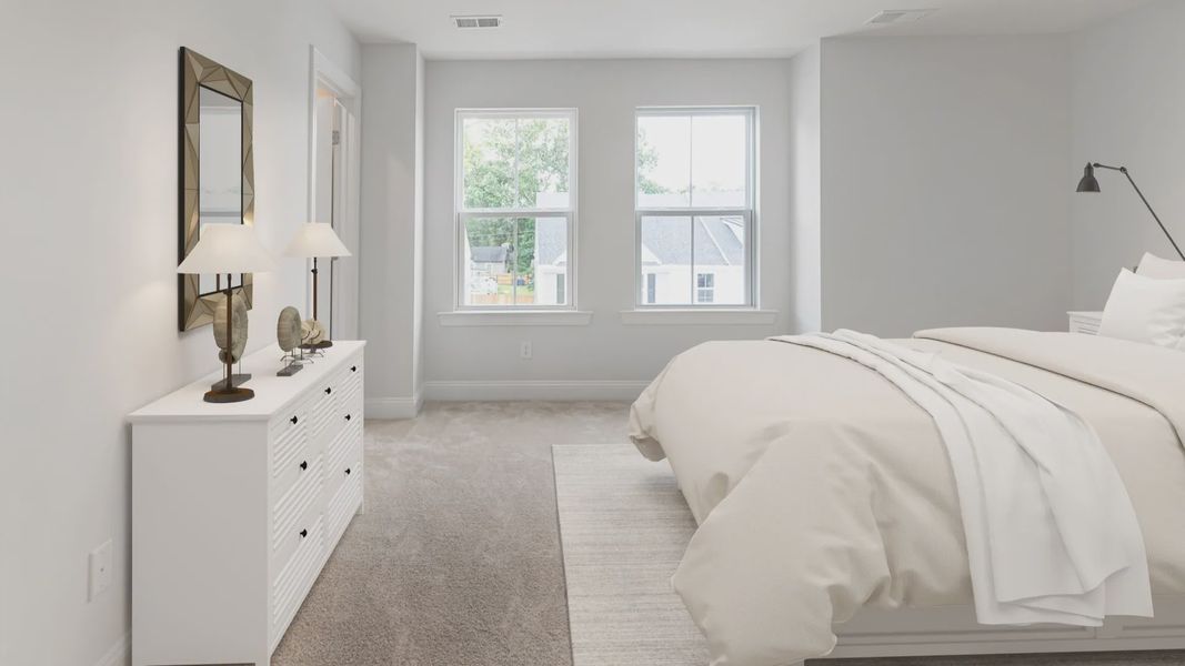 Carpeted owner's suite with two large windows on single wall in a DRB Homes Brookgreen model home