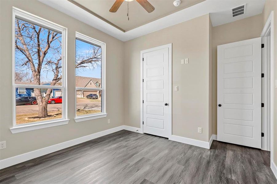 Unfurnished bedroom featuring dark hardwood / wood-style flooring